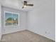 Light-filled bedroom with neutral carpet, ceiling fan, and window providing natural light at 13810 N 39Th Ave, Phoenix, AZ 85053