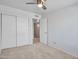 Bright bedroom features a ceiling fan, closet, and entry to the hallway at 13810 N 39Th Ave, Phoenix, AZ 85053