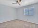 A cozy bedroom featuring neutral carpet, ceiling fan, and a window with blinds at 13810 N 39Th Ave, Phoenix, AZ 85053