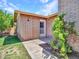 Exterior view of brick home showing back door surrounded by lush greenery and mature landscaping at 13810 N 39Th Ave, Phoenix, AZ 85053