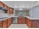 Kitchen features wood cabinets, tile floors, and ample counter space at 13810 N 39Th Ave, Phoenix, AZ 85053
