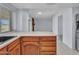 Bright kitchen featuring solid surface countertops, oak cabinetry and an open view of the adjacent living room at 13810 N 39Th Ave, Phoenix, AZ 85053