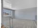 Bright living room with a neutral carpet, large window for natural light, and a staircase with a railing at 13810 N 39Th Ave, Phoenix, AZ 85053