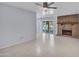 Bright living room features tile floors, brick fireplace, and neutral paint at 13810 N 39Th Ave, Phoenix, AZ 85053