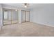 Spacious main bedroom featuring mirrored closet doors and ceiling fan at 13810 N 39Th Ave, Phoenix, AZ 85053