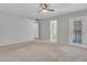 Large main bedroom featuring en suite bathroom, sliding glass doors, and ceiling fan at 13810 N 39Th Ave, Phoenix, AZ 85053