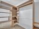 Spacious walk-in closet featuring built-in storage shelves and hanging rods at 13810 N 39Th Ave, Phoenix, AZ 85053