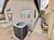 Exterior view of the home with an air conditioner and outdoor sink at 14345 N 101St St, Scottsdale, AZ 85260