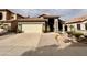 Inviting single-Gathering home showcasing desert landscaping and a convenient two-car garage at 14345 N 101St St, Scottsdale, AZ 85260