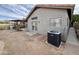Rear exterior view showcasing the patio, air conditioner, and stucco siding at 14345 N 101St St, Scottsdale, AZ 85260