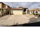 Charming single-Gathering home with a tile roof, desert landscaping, and a two-car garage at 14345 N 101St St, Scottsdale, AZ 85260