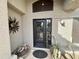 Elegant front entrance with a decorative door, potted plants, and stylish outdoor decor at 14345 N 101St St, Scottsdale, AZ 85260