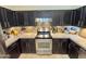 Updated kitchen with stainless steel appliances, dark cabinets and tiled backsplash at 14345 N 101St St, Scottsdale, AZ 85260