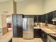 The kitchen features black cabinets and stainless steel refrigerator at 14345 N 101St St, Scottsdale, AZ 85260
