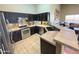 Well-appointed kitchen with ample counter space, dark cabinetry and stainless steel appliances at 14345 N 101St St, Scottsdale, AZ 85260