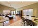 Open concept living room and dining area with vaulted ceilings and a leather sectional sofa at 14345 N 101St St, Scottsdale, AZ 85260