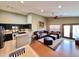Open concept living space with kitchen, breakfast bar, and wrap around couch at 14345 N 101St St, Scottsdale, AZ 85260