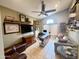 Comfortable office space featuring a TV, a ceiling fan, and a built-in desk area at 14345 N 101St St, Scottsdale, AZ 85260
