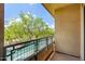 Secluded balcony showcasing mature trees and a quiet neighborhood view at 16 W Encanto Blvd # 26, Phoenix, AZ 85004