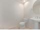Powder room with pedestal sink and toilet with neutral color palette at 16 W Encanto Blvd # 26, Phoenix, AZ 85004