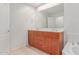 Bathroom showing a vanity with double sinks, a large mirror, and tile flooring at 16 W Encanto Blvd # 26, Phoenix, AZ 85004