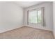Bedroom featuring neutral carpet, a window with blinds, and lots of natural light at 16 W Encanto Blvd # 26, Phoenix, AZ 85004