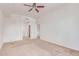 Carpeted bedroom with access to a bathroom and a view of the stairs at 16 W Encanto Blvd # 26, Phoenix, AZ 85004