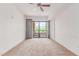 Bright and airy bedroom featuring neutral carpet, balcony access, and ceiling fan at 16 W Encanto Blvd # 26, Phoenix, AZ 85004