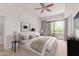 Bright bedroom featuring a ceiling fan, balcony access, and stylish decor for a comfortable living space at 16 W Encanto Blvd # 26, Phoenix, AZ 85004