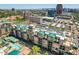 An aerial view of a condo building with a pool and a city skyline backdrop at 16 W Encanto Blvd # 26, Phoenix, AZ 85004