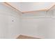 View of the closet with wooden rods and shelves for optimal storage solutions at 16 W Encanto Blvd # 26, Phoenix, AZ 85004