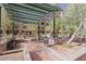 Lush courtyard featuring benches, palm trees, manicured landscaping, and covered area at 16 W Encanto Blvd # 26, Phoenix, AZ 85004