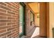Brick exterior with glass paneled door, exterior lighting and covered walkway at 16 W Encanto Blvd # 26, Phoenix, AZ 85004