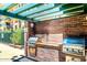 Community grill area featuring brick surround, stainless steel grills, and covered canopy at 16 W Encanto Blvd # 26, Phoenix, AZ 85004