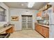 Cozy kitchenette featuring granite counters, wood cabinets, and tiled floors near double doors at 16 W Encanto Blvd # 26, Phoenix, AZ 85004
