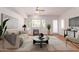 Bright living room featuring a fireplace, ceiling fan, and large windows providing ample natural light at 16 W Encanto Blvd # 26, Phoenix, AZ 85004