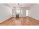 Spacious living room with hardwood floors, large window, and fireplace at 16 W Encanto Blvd # 26, Phoenix, AZ 85004