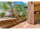 Brick patio with manicured landscaping, flowering plants and desert foliage at 16 W Encanto Blvd # 26, Phoenix, AZ 85004