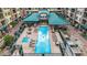 Aerial view of an inviting pool area with lounge chairs, tables, and lush landscaping at 16 W Encanto Blvd # 26, Phoenix, AZ 85004