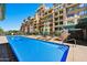 Community pool featuring in-water logo, lounge chairs, and well-maintained landscaping at 16 W Encanto Blvd # 26, Phoenix, AZ 85004