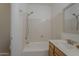 Bathroom featuring a tub with shower, a mirror and wooden vanity at 1650 S Crismon Rd # 63, Mesa, AZ 85209