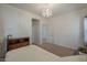 Bright bedroom featuring soft carpet, chandelier, archway, and access to adjacent room at 1650 S Crismon Rd # 63, Mesa, AZ 85209