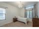 Cozy bedroom with a large window, small bed, and charming chandelier at 1650 S Crismon Rd # 63, Mesa, AZ 85209