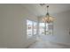 Bright dining area features tile flooring, chandelier, and large windows, perfect for Gathering meals at 1650 S Crismon Rd # 63, Mesa, AZ 85209