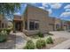 Charming single-story home features a textured facade, desert landscaping, and a private garage at 1650 S Crismon Rd # 63, Mesa, AZ 85209
