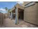 Exterior view of a covered patio with gravel landscaping, and blue curtains at 1650 S Crismon Rd # 63, Mesa, AZ 85209