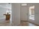 Bright foyer featuring travertine tile, clerestory window and an open view to the kitchen at 1650 S Crismon Rd # 63, Mesa, AZ 85209