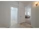Hallway leading to living room and laundry room featuring white walls and tile flooring at 1650 S Crismon Rd # 63, Mesa, AZ 85209
