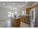 Bright kitchen with stainless appliances, center island, breakfast bar, and tile flooring at 1650 S Crismon Rd # 63, Mesa, AZ 85209
