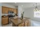Cozy kitchen featuring stainless steel appliances, tile flooring, and a breakfast bar at 1650 S Crismon Rd # 63, Mesa, AZ 85209